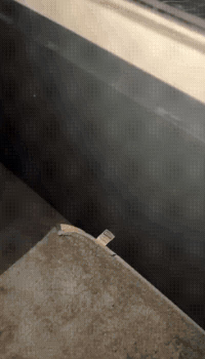 A Piece Of Paper Is Laying On A Table Next To A Wall GIF