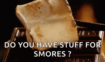 A Piece Of S'mores Is Sitting On Top Of A Piece Of Chocolate .. GIF