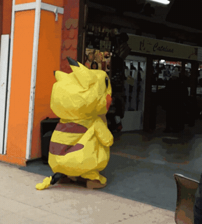 A Pikachu Costume Is Standing In Front Of A Store That Says Catalina GIF