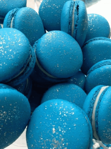 A Pile Of Blue Macarons With Silver Sprinkles GIF