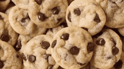 A Pile Of Chocolate Chip Cookies Looks Like A Pile Of Faces GIF