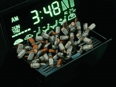 A Pile Of Cigarettes Sits In Front Of A Digital Clock That Says 3:48 GIF