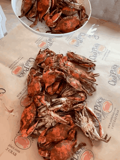 A Pile Of Crabs Sits On A Table Next To A Bowl Of Crabs From The Club Place GIF