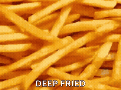 A Pile Of Deep Fried French Fries With The Words `` Deep Fried '' Written On It . GIF