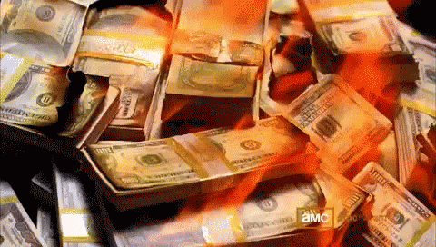 A Pile Of Money Is Burning With The Letters Amc Visible On The Bottom GIF