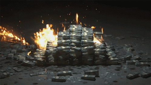 A Pile Of Money Is On Fire With A Stack Of Twenty Dollar Bills In The Foreground GIF