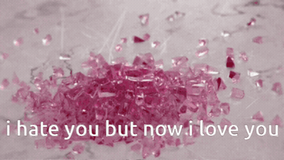 A Pile Of Pink Crystals With The Words " I Hate You But Now I Love You " Below Them GIF