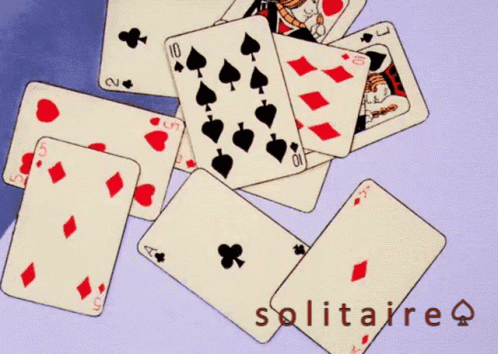 A Pile Of Playing Cards And An Envelope With The Word Solitaire On The Bottom GIF