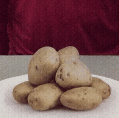 A Pile Of Potatoes Is On A White Plate GIF