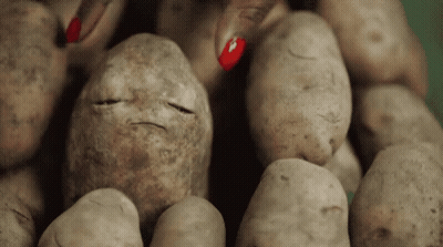 A Pile Of Potatoes With A Face Drawn On One Of Them GIF