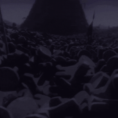 A Pile Of Purple Rocks In Front Of A Purple Pyramid GIF