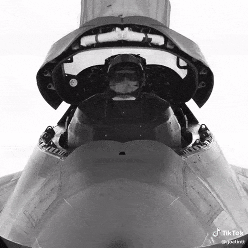 A Pilot Is Sitting In The Cockpit Of A Fighter Jet GIF
