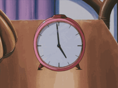 A Pink Alarm Clock On A Table Shows The Time As 5:00 GIF