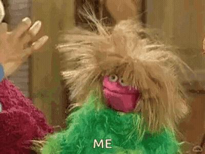 A Pink And Green Puppet With A Messy Haircut Is Standing Next To A Green Puppet . GIF