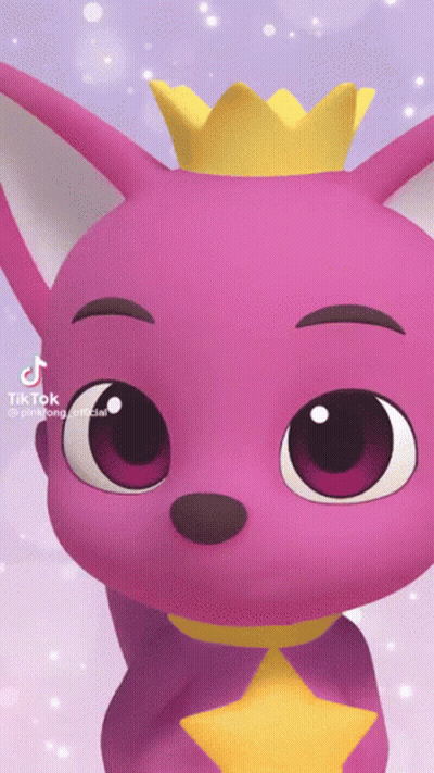 A Pink Baby Shark With A Yellow Crown On His Head GIF