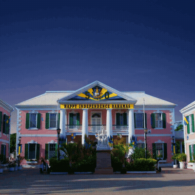 A Pink Building With The Words Happy Independence Bahamas On The Top GIF