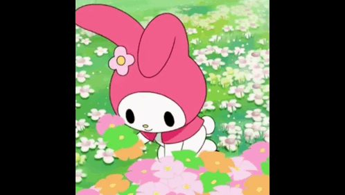 A Pink Bunny Rabbit With A Flower On Her Head Is Standing In A Field Of Flowers . GIF