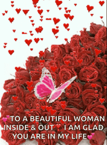 A Pink Butterfly Is Sitting On Top Of A Pile Of Red Roses GIF