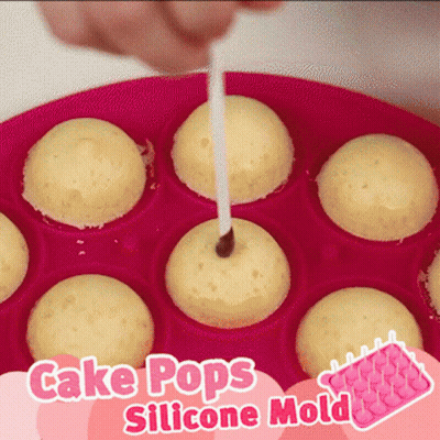 A Pink Cake Pops Silicone Mold With A Person Sticking A Stick In It GIF