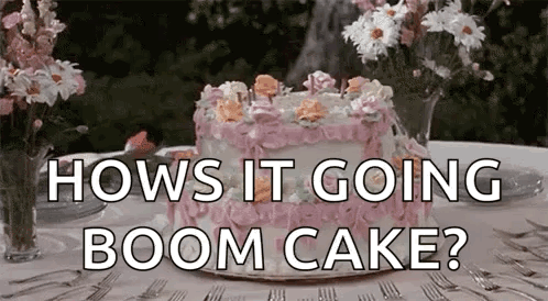 A Pink Cake With Flowers On It Is On A Table With The Words `` How 'S It Going Boom Cake ? '' GIF