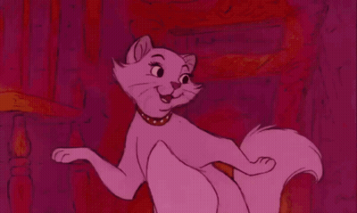 A Pink Cat Wearing A Gold Collar Is Sitting On A Pink Background . GIF