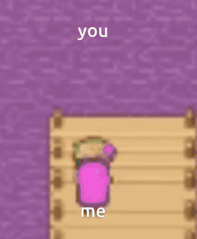 A Pink Cube Is Sitting On A Wooden Dock Next To A Purple Wall And Says You Me GIF