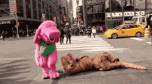 A Pink Dinosaur Is Standing Next To A Brown Dinosaur On A Street GIF