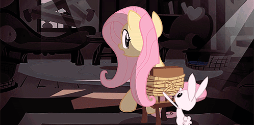 A Pink Pony Is Tied To A Chair Next To A White Pony GIF