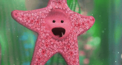 A Pink Starfish With A Face On It Is Swimming In A Tank . GIF