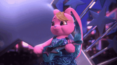 A Pink Stuffed Animal Is Holding A Star In Her Hand GIF