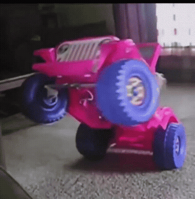 A Pink Toy Jeep With Blue Wheels And Tires GIF