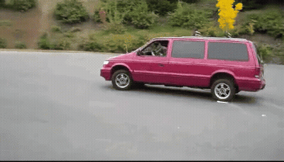 A Pink Van Is Driving Down A Road GIF