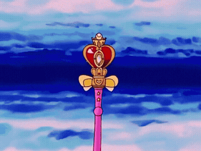 A Pink Wand With A Heart Shaped Top And A Crown On Top GIF