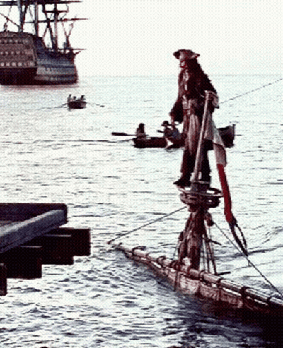 A Pirate Is Standing On A Boat In The Water GIF