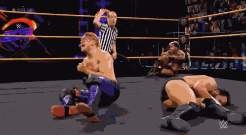 A Pixel Art Of Wrestlers In A Wrestling Ring With A Referee And A W Logo In The Background GIF