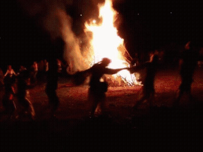 A Pixelated Image Of A Man Dancing In Front Of A Fire GIF
