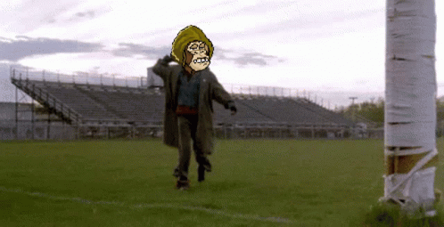 A Pixelated Image Of A Man In A Hooded Jacket Walking On A Field GIF