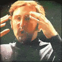 A Pixelated Image Of A Man In A Suit Holding His Head GIF
