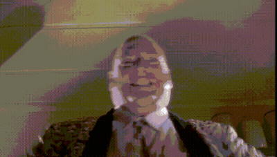 A Pixelated Image Of A Man In A Suit GIF