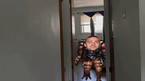 A Pixelated Image Of A Man 'S Face In A Hallway GIF