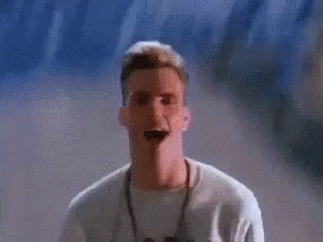 A Pixelated Image Of A Man Standing In Front Of A Wall With The Letter C In The Background GIF