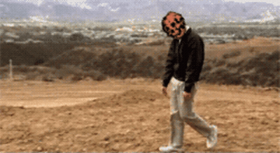 A Pixelated Image Of A Man With A Pumpkin Face On His Head GIF