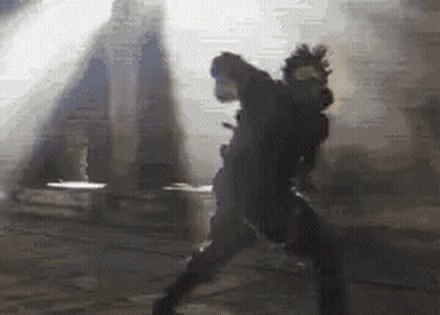 A Pixelated Image Of A Person Standing In The Dark GIF