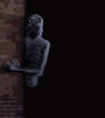 A Pixelated Image Of A Skeleton Peeking Out Of A Doorway . GIF