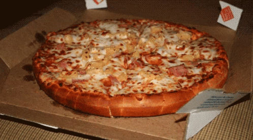 A Pizza In A Cardboard Box With A Domino 'S Sticker On It GIF