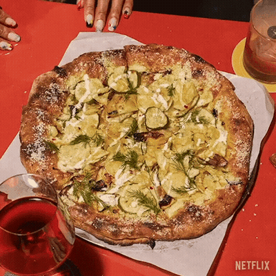 A Pizza With A Glass Of Wine Next To It And A Netflix Logo GIF