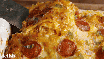 A Pizza With Pepperoni And Cheese Is Being Scooped Out Of A Casserole Dish By A Spatula .. GIF