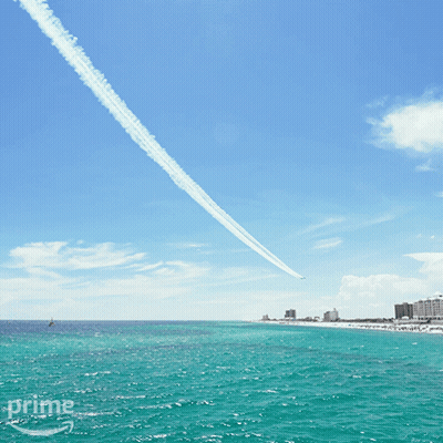 A Plane Flying Over A Body Of Water With The Word Prime In The Corner GIF
