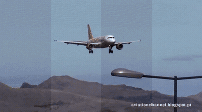 A Plane Is Flying Over A Street Light With The Words Aviationchannel.blogspot.pt Written Below It GIF