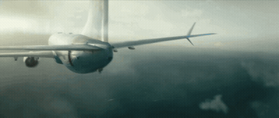 A Plane Is Flying Through A Cloudy Sky With A Blue Tail GIF